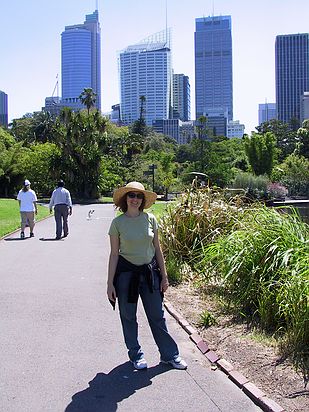 Samantha in the gardens with part of the Sydney skyline